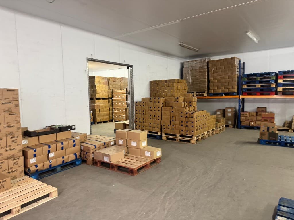 Warehouse interior with racking and stacked cardboard cases